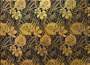 Gold Plumeria and Monstera leaf pattern on a black background. Picture shows entire width of the fabric . 
