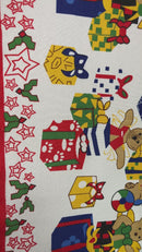 A festive white polyester fabric featuring a repeating holiday pattern of smiling snowmen, teddy bears, Christmas trees, and colorful gift boxes, bordered on the left by a red vertical band with white star and snowflake motifs.